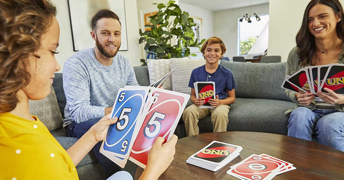family playing with giant uno cards in their living room