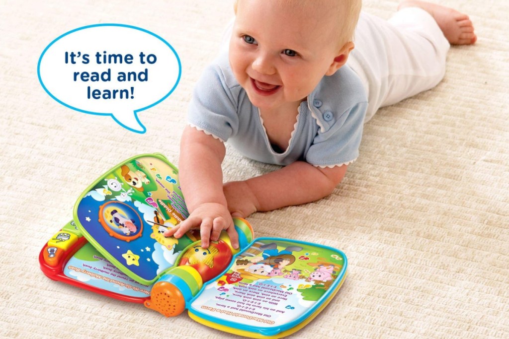 baby playing on the floor with a VTech Musical Rhymes Book