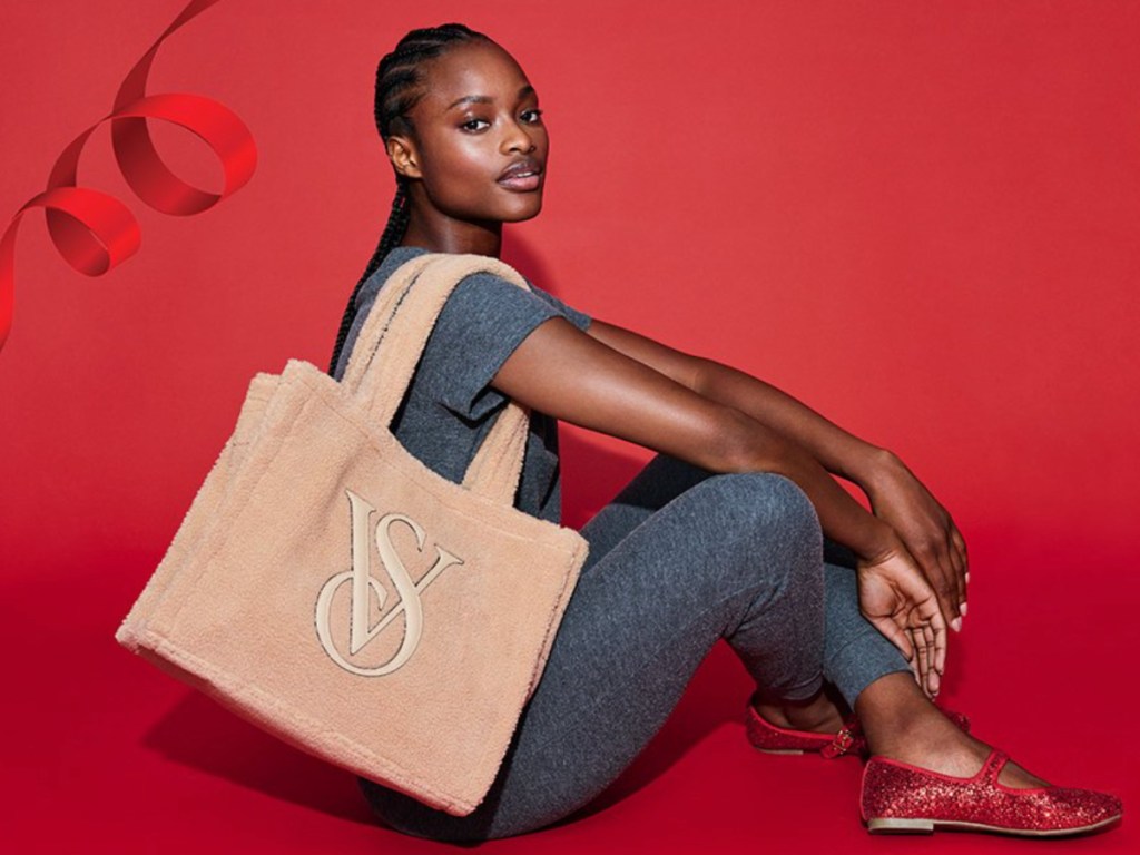 Woman sitting on floor with brown Victoria's Secret Tote