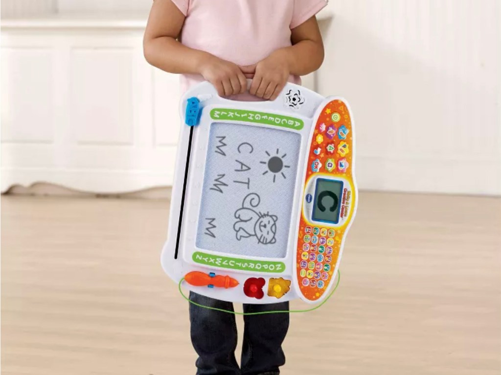 child with vtech write and learn creative toy