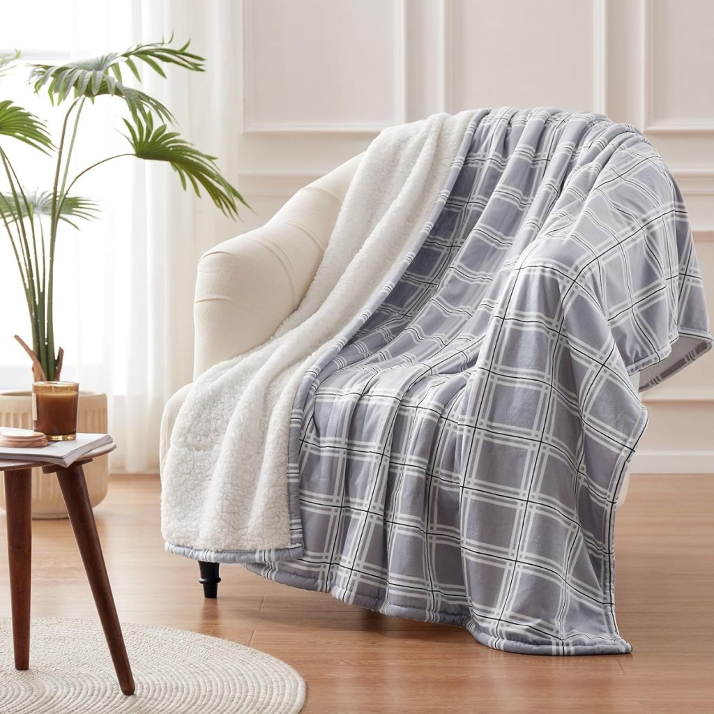 A plaid westinghouse heated blanket draped over a chair