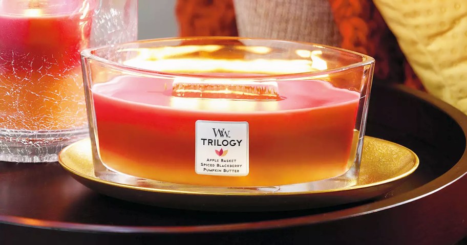 large layered candle burning on top of a plate