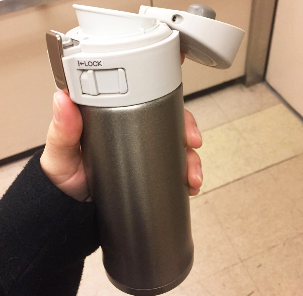 hand holding gold Zojirushi 12oz Stainless Steel Mug