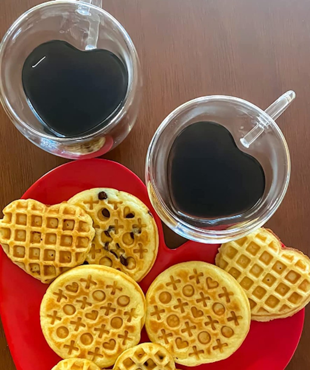 heart shaped cups with red plate and waffles on table
