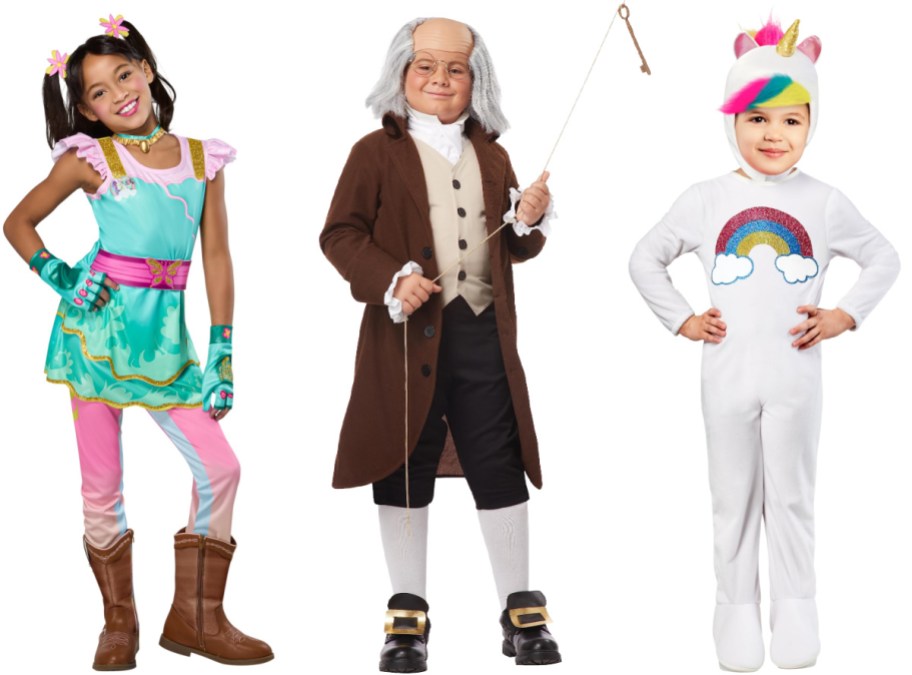 Three children modeling Halloween costumes side by side, featuring a colorful unicorn academy outfit on the left, a historical Benjamin Franklin costume in the center, and a white unicorn and rainbow jumpsuit on the right.