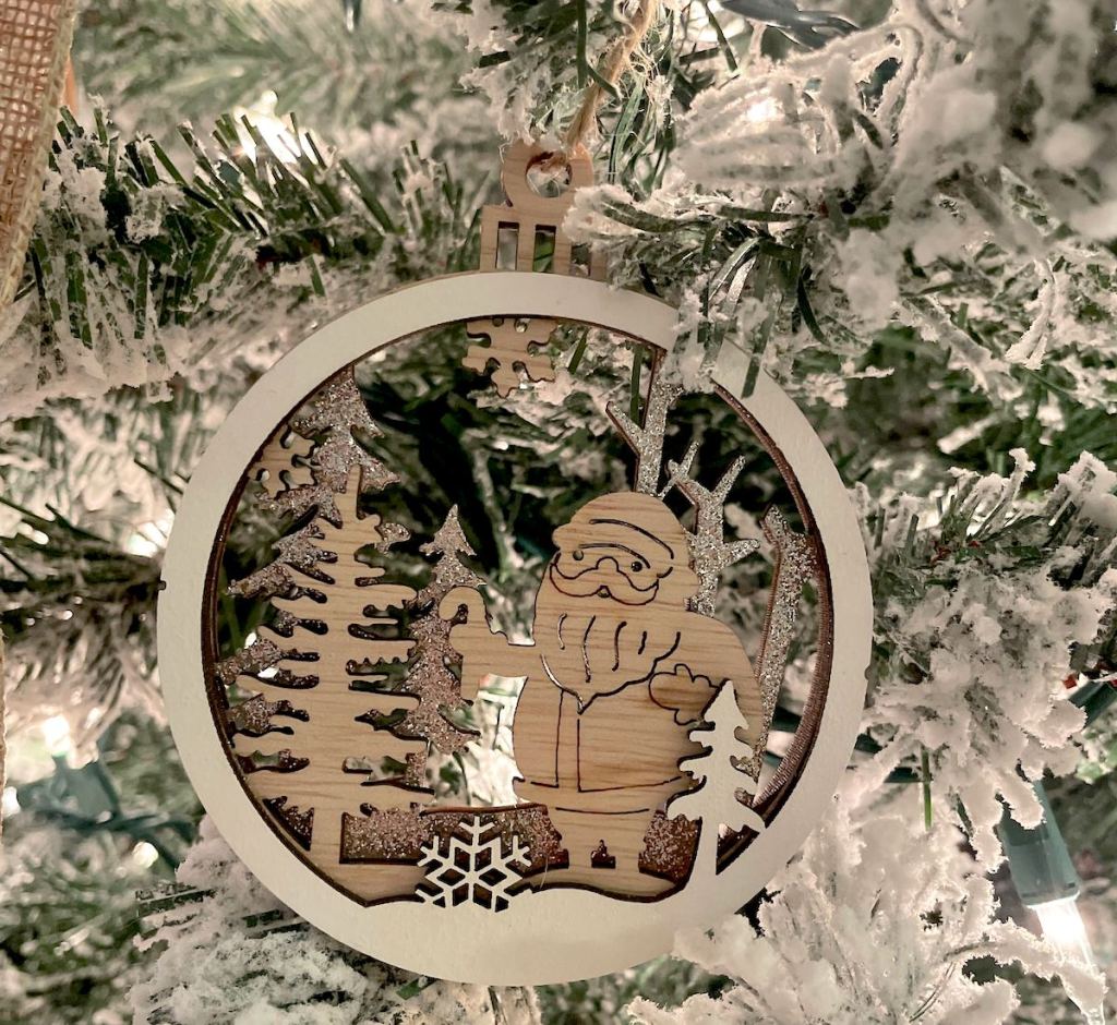 wood santa ornament on christmas tree 
