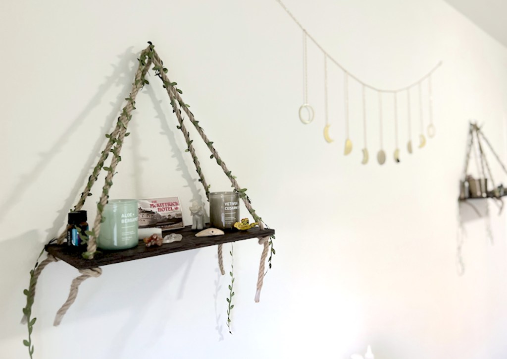hanging wood shelf with moon garland hanging on wall