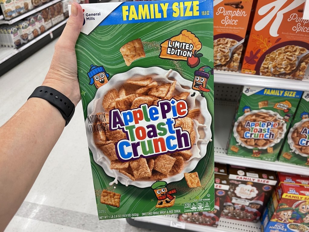 holding a box of Apple Pie Toast Crunch