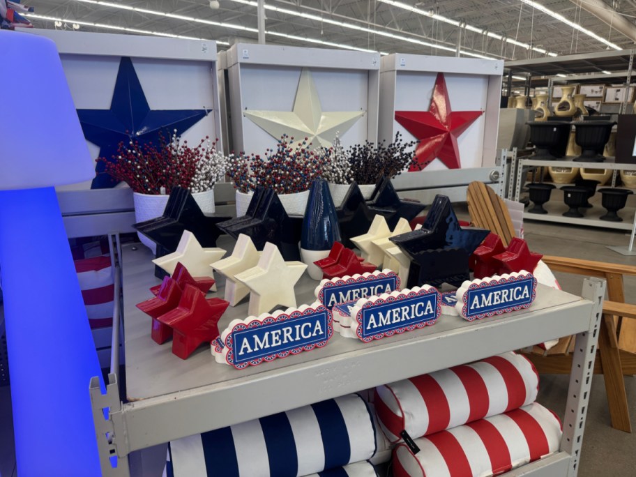 Store display with red, white, and blue stars, "America" signs, and patriotic-themed decor.