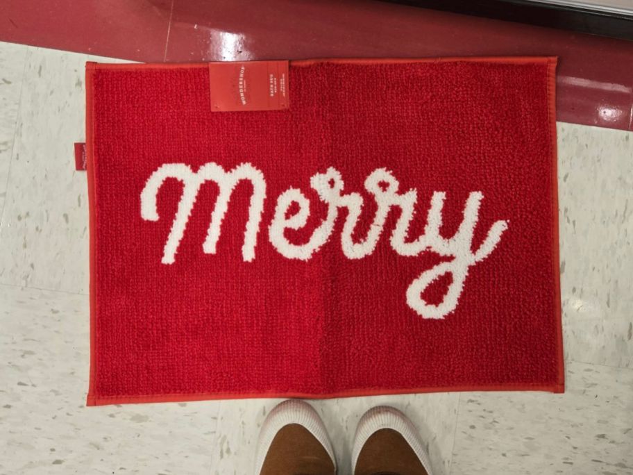 red 'Merry' Christmas Bath Rug on floor in store
