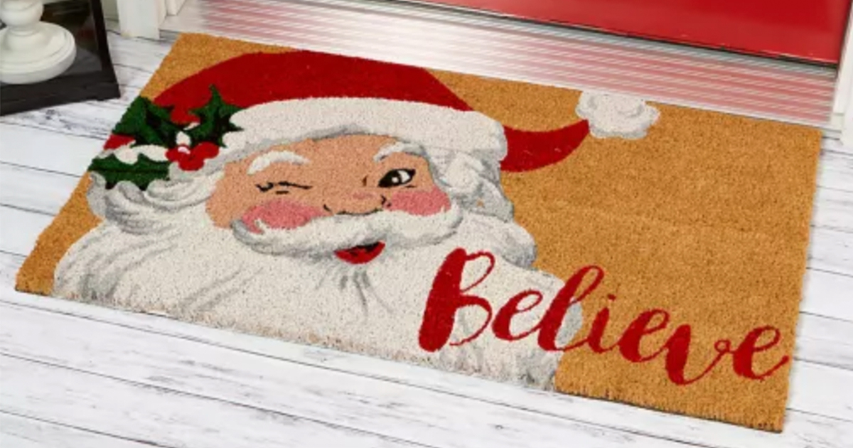 christmas doormat with a winking Santa and the word Believe