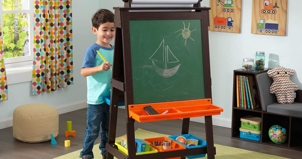 child with crafts easel