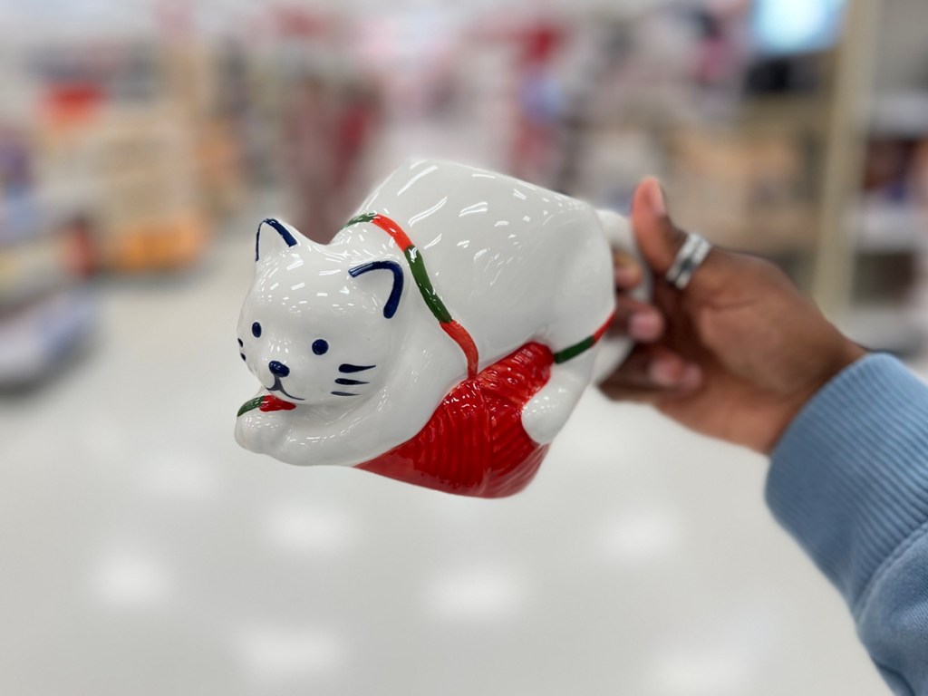 woman holding Christmas mug in target