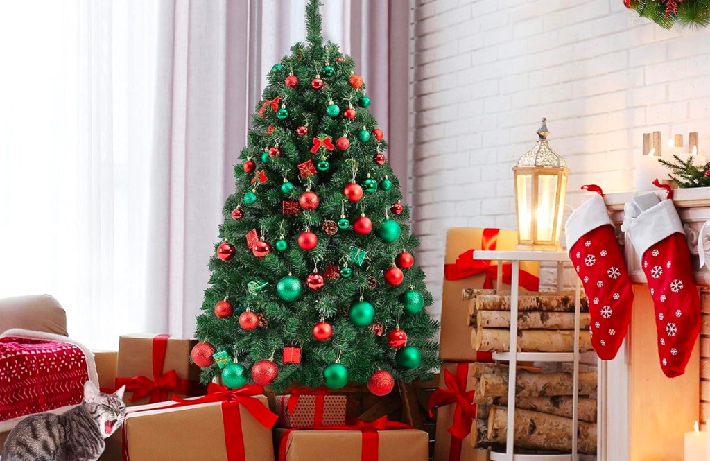 christmas tree with green and red ornaments with christmas gifts under it