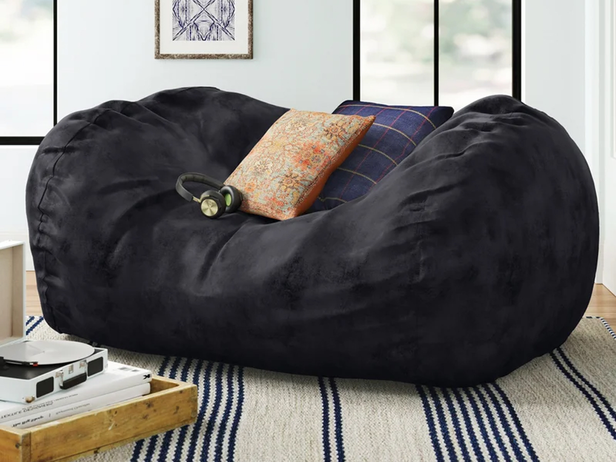 bean bag lounger with pillows and a pair of headphones near a record player