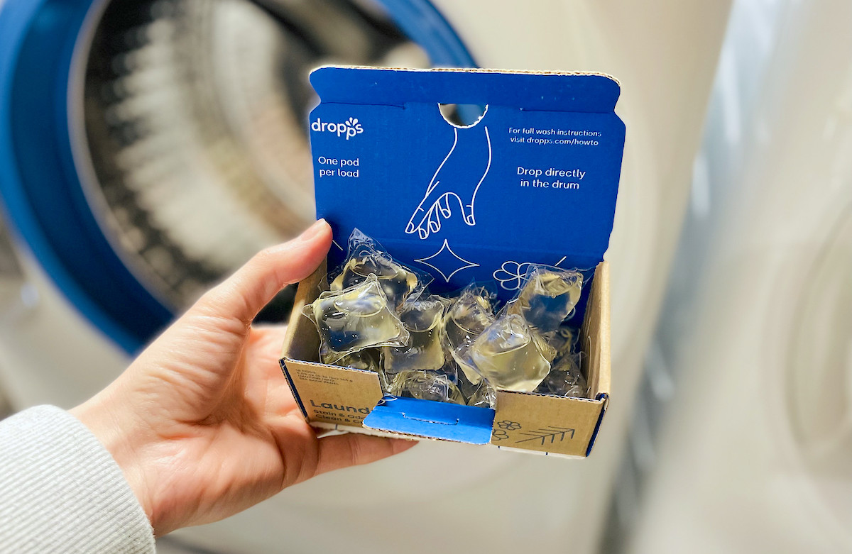 hand holding a box of dropps laundry pods