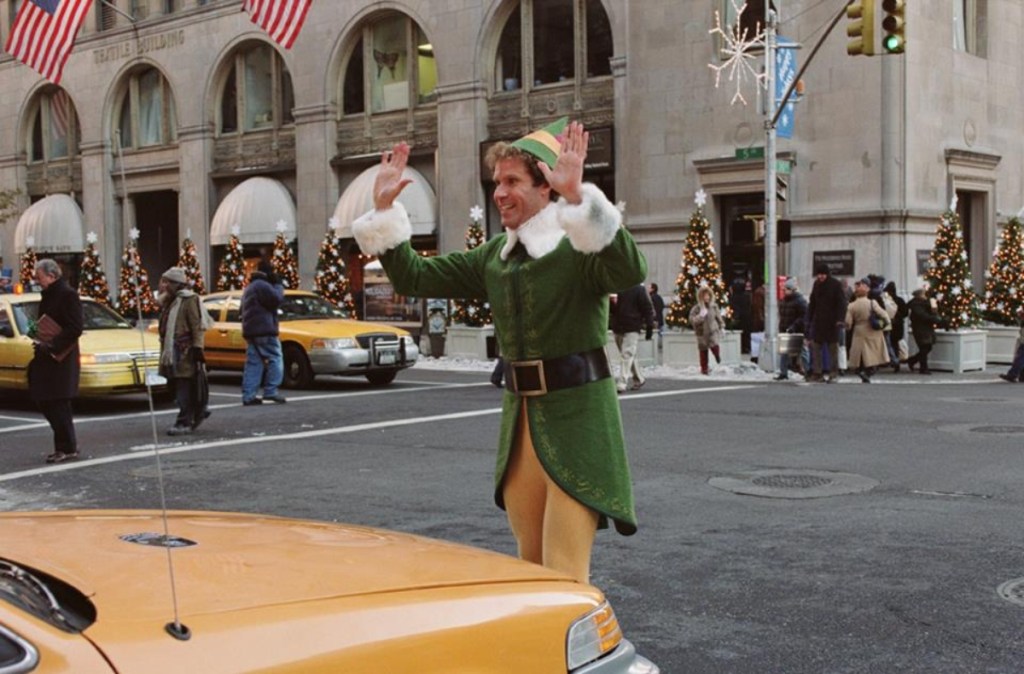elf standing in front of NYC taxi