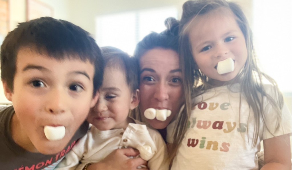 family with marshmallows in mouth