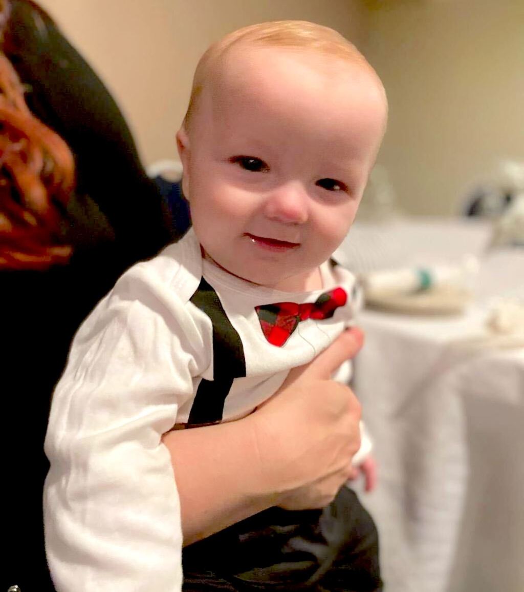 baby wearing formal bodysuit with bowtie