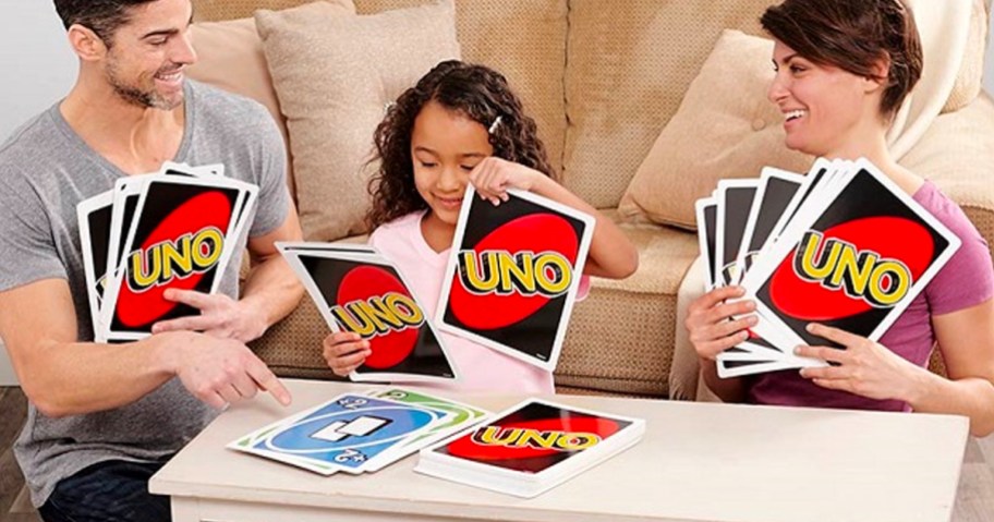 family playing with giant uno cards