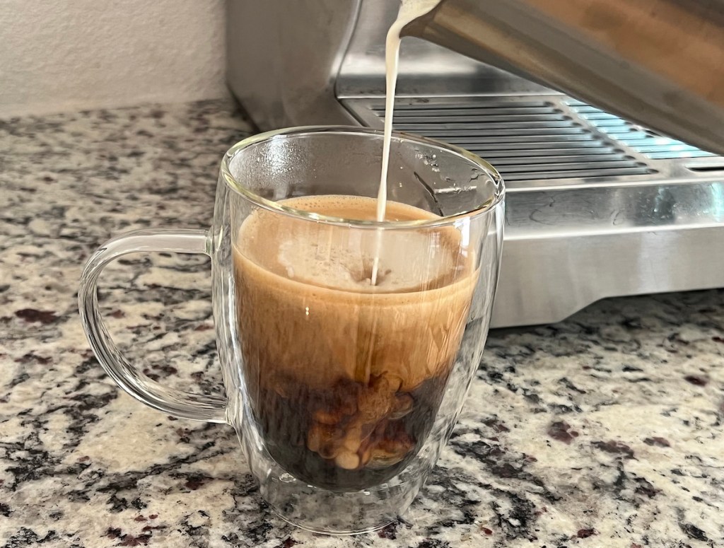 pouring coffee into glass coffee mug