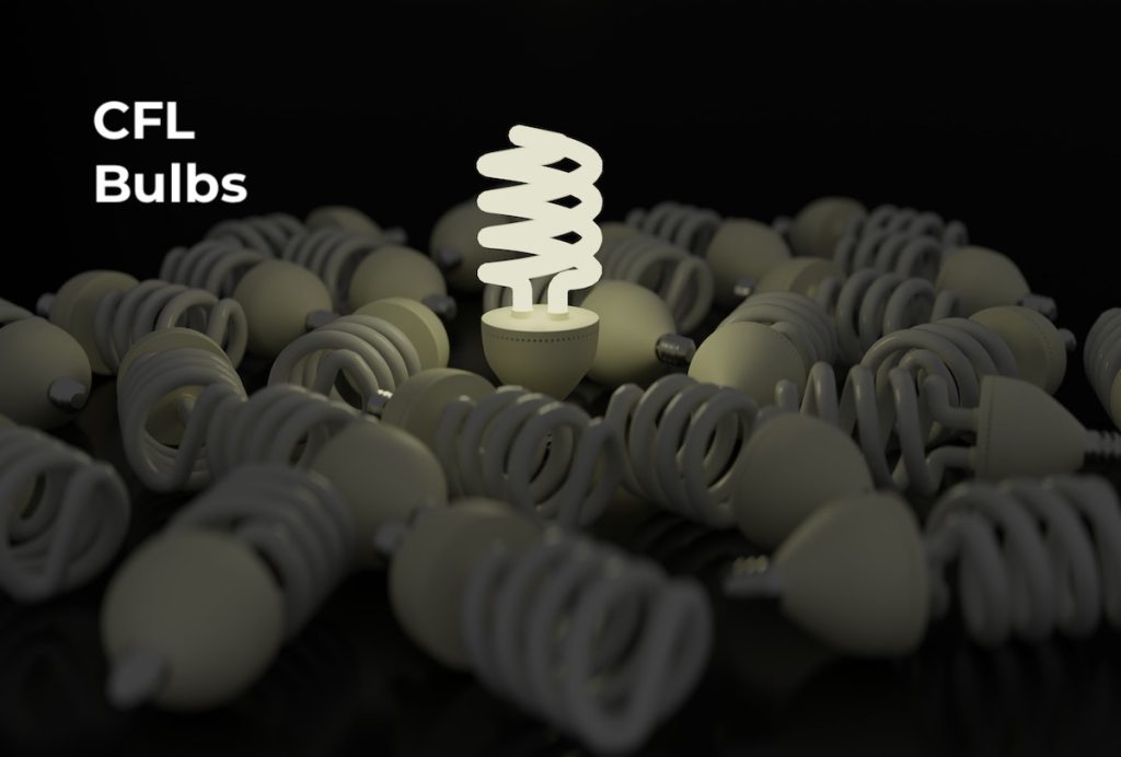 pile of cfl bulbs with one bright bulb in the middle of dark room