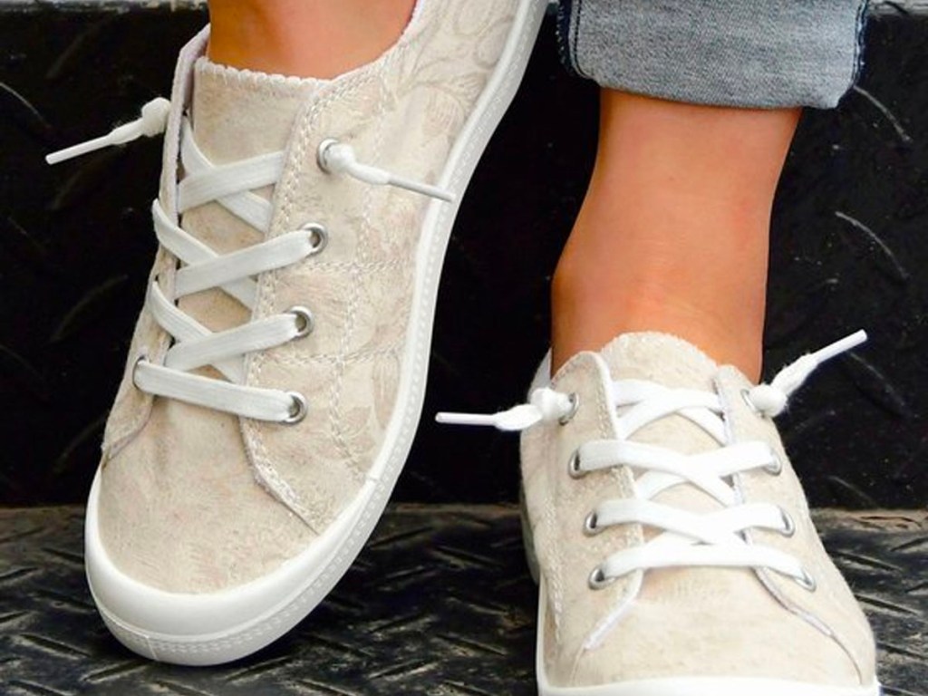 close up of woman wearing khaki floral boat shoes