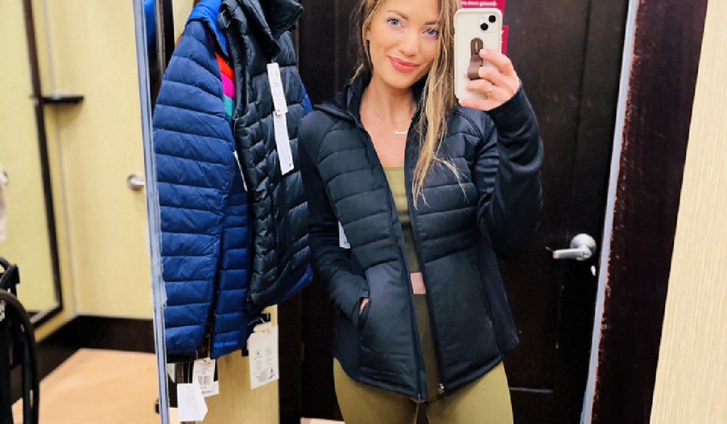 woman wearing a kohl's tek gear women's jacket in a fitting room