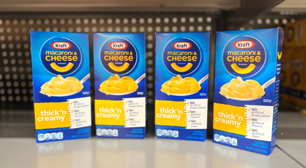 four kraft mac cheese boxes lined up on a store shelf