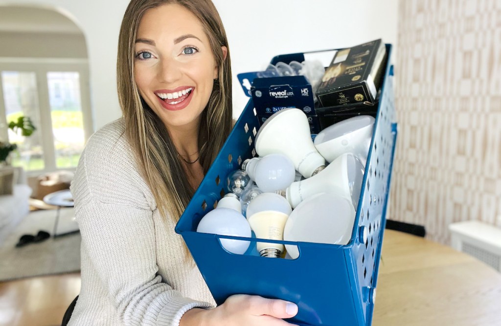 woman holding blue tin full of light bulbs
