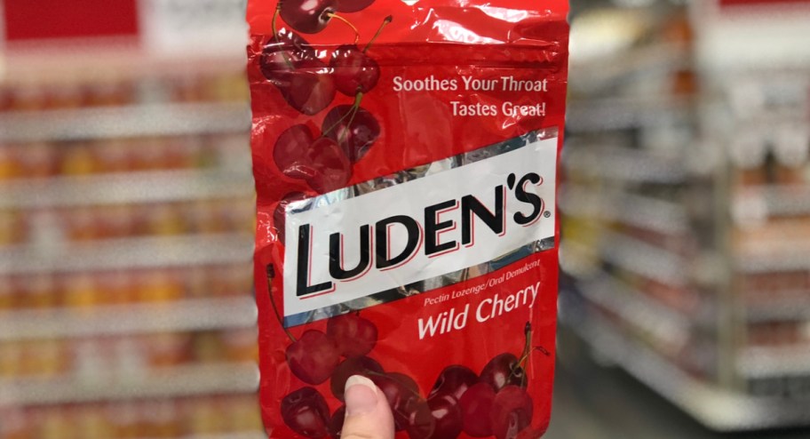 hand holding bag of luden's wild cherry cough drops