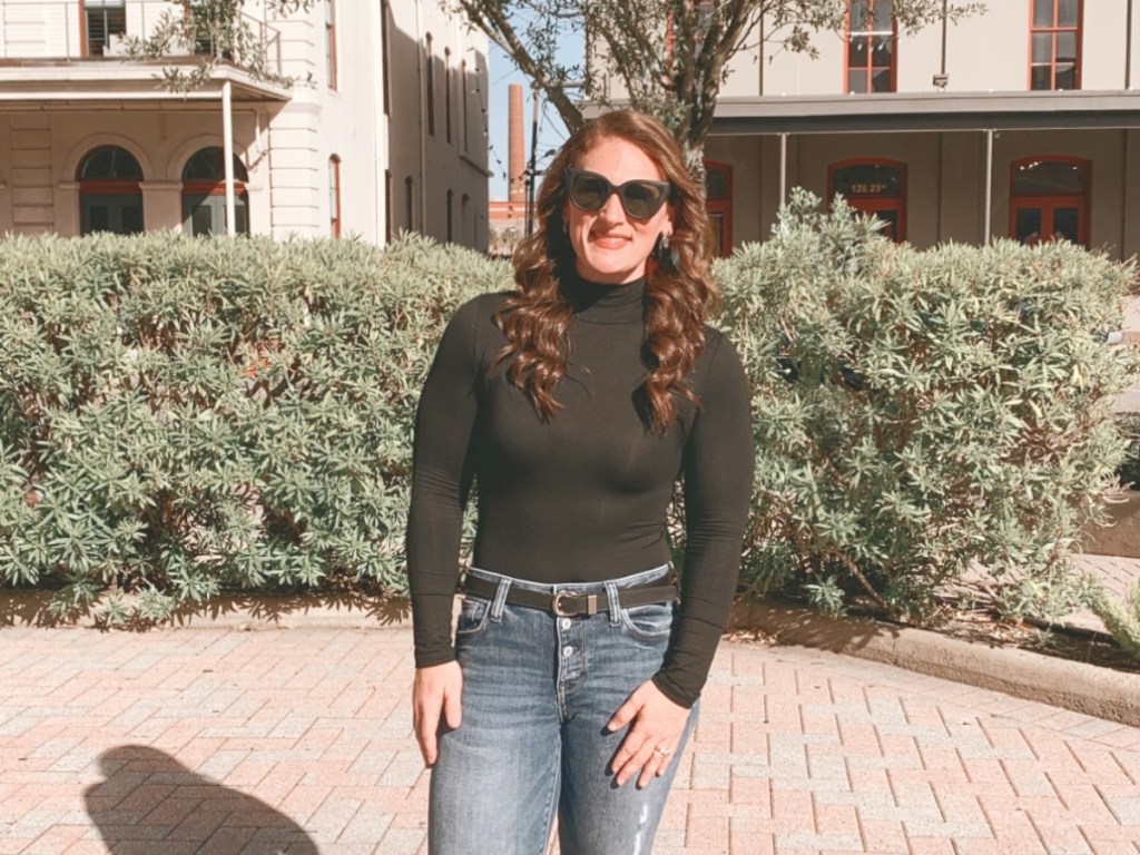 woman wearing black turtleneck and jeans