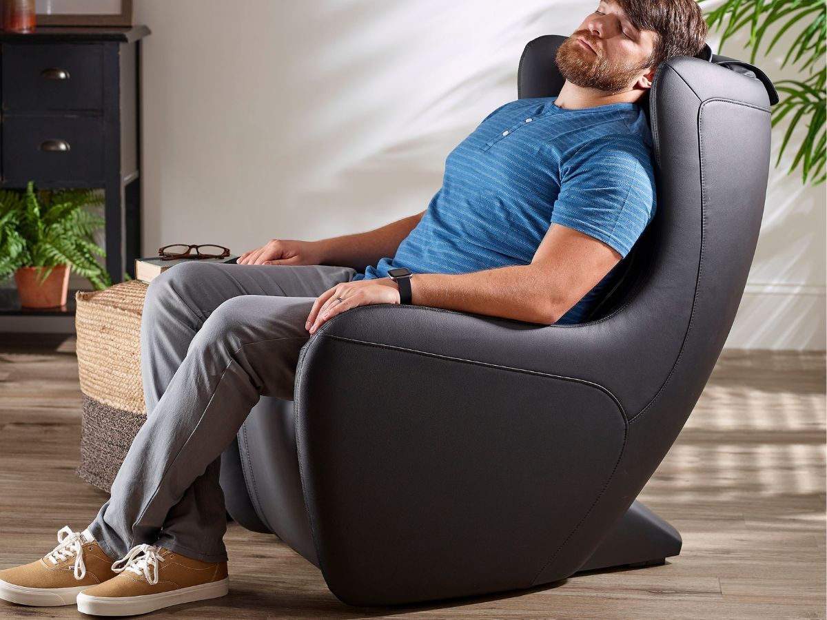 man sitting in an insignia massage chair