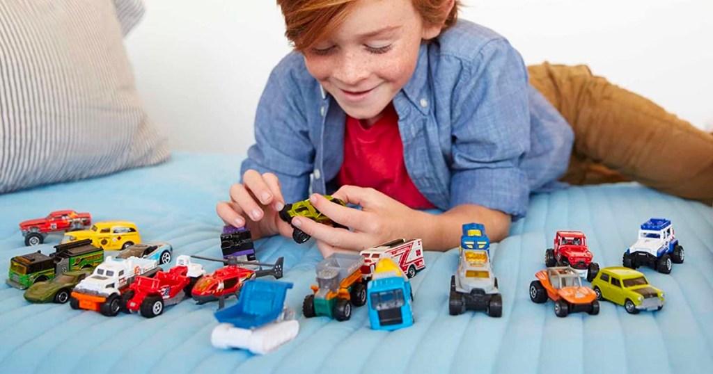child playing with matchbox cars