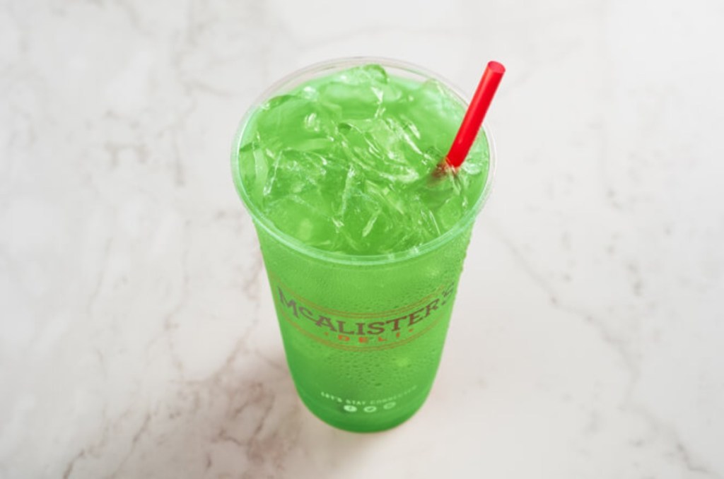 green beverage with ice and a straw