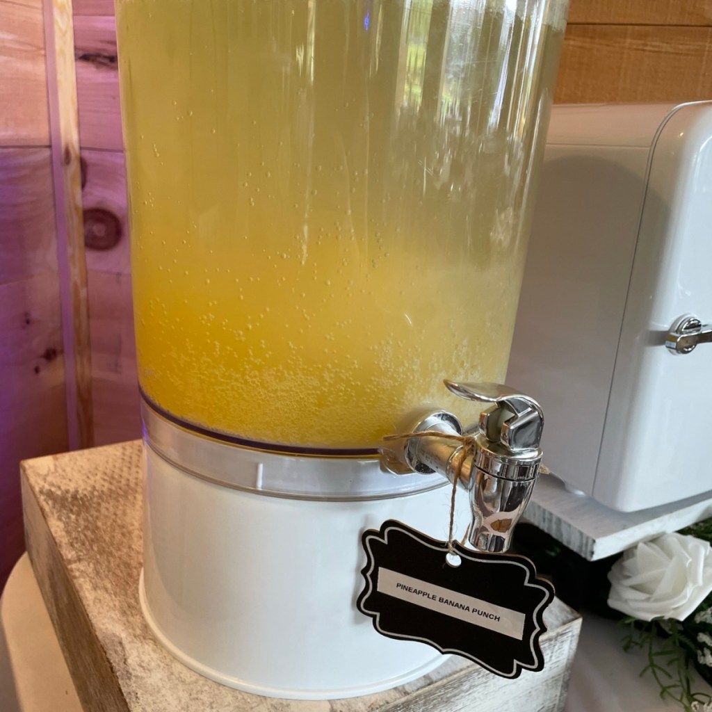yellow beverage in clear drink dispenser