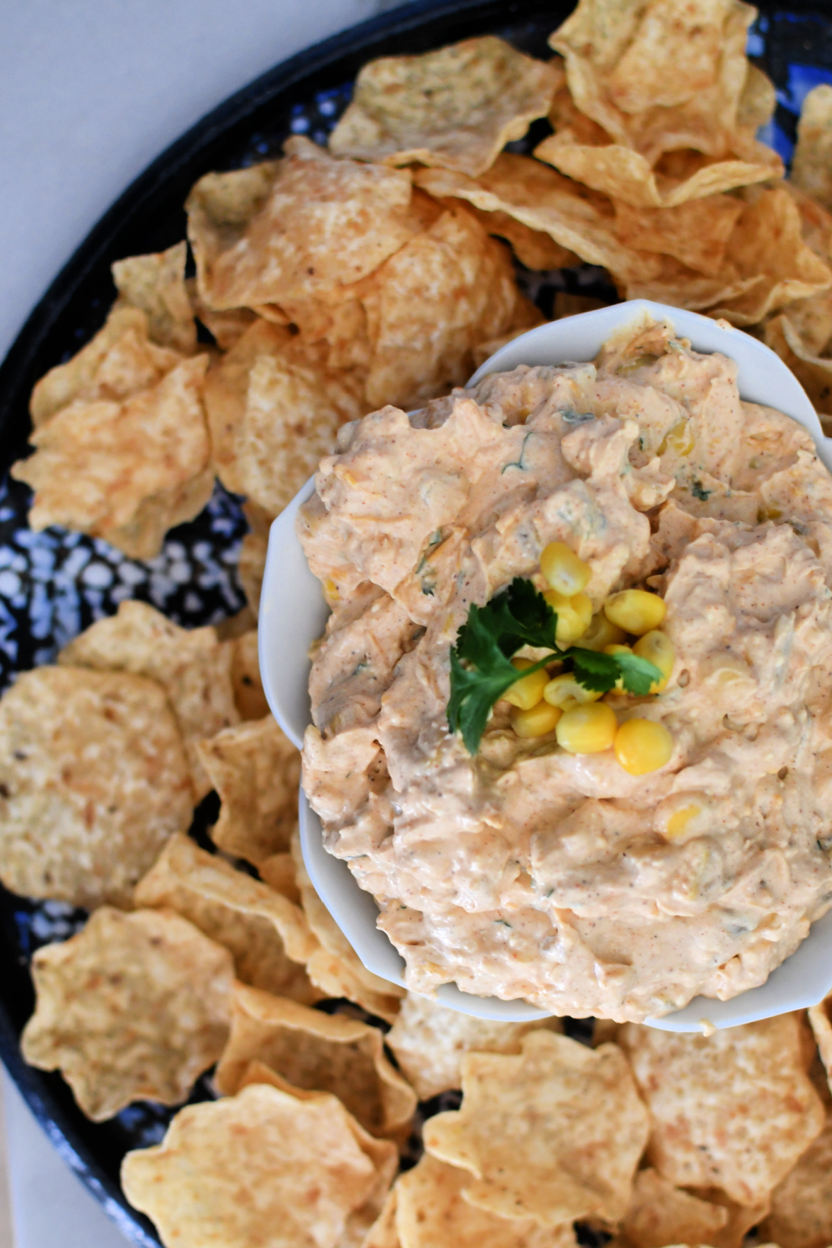 platter with chips and mexican corn dip
