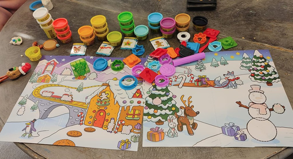 contents of the play doh advent calendar spread out on a table