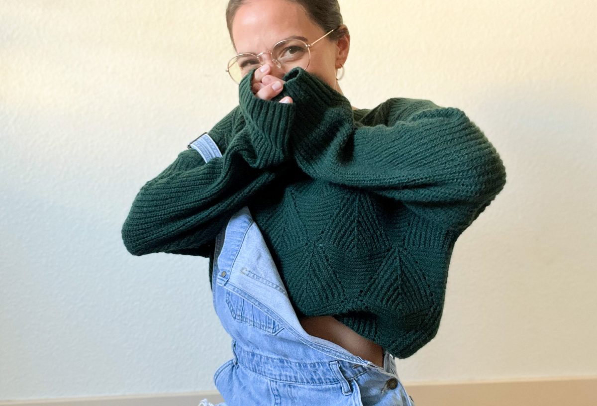 woman in green sweater with overalls