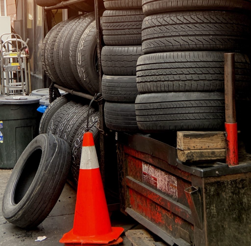 piles of tires on large recycling dumpster