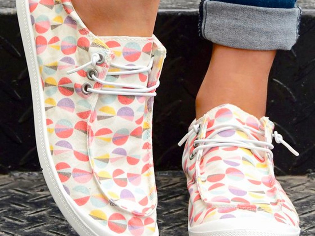 close up of woman wearing colorful circle boat shoes