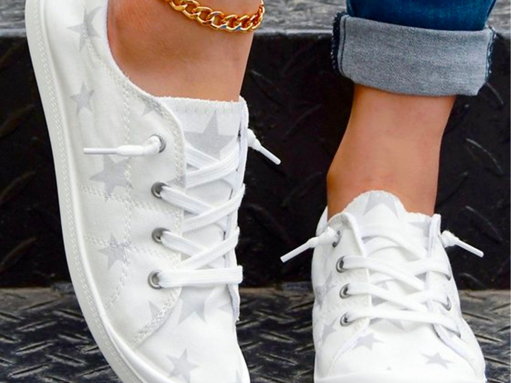 close up of woman wearing star boat shoes