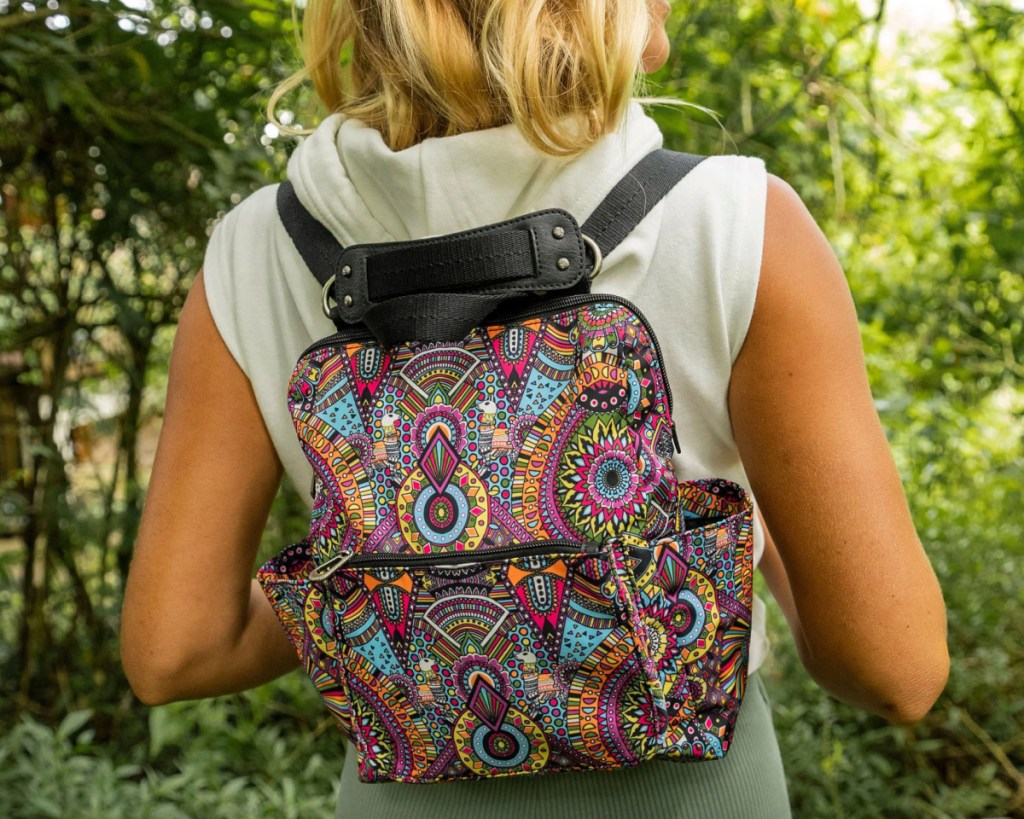 woman outside with multicolored small backpack