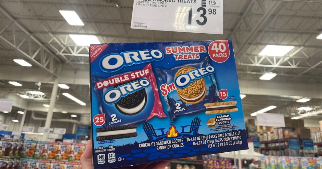 holding a box of Oreo snack packs