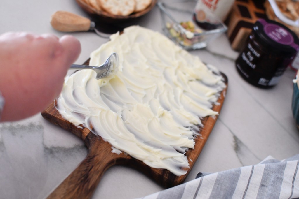 spreadding butter on a wood board