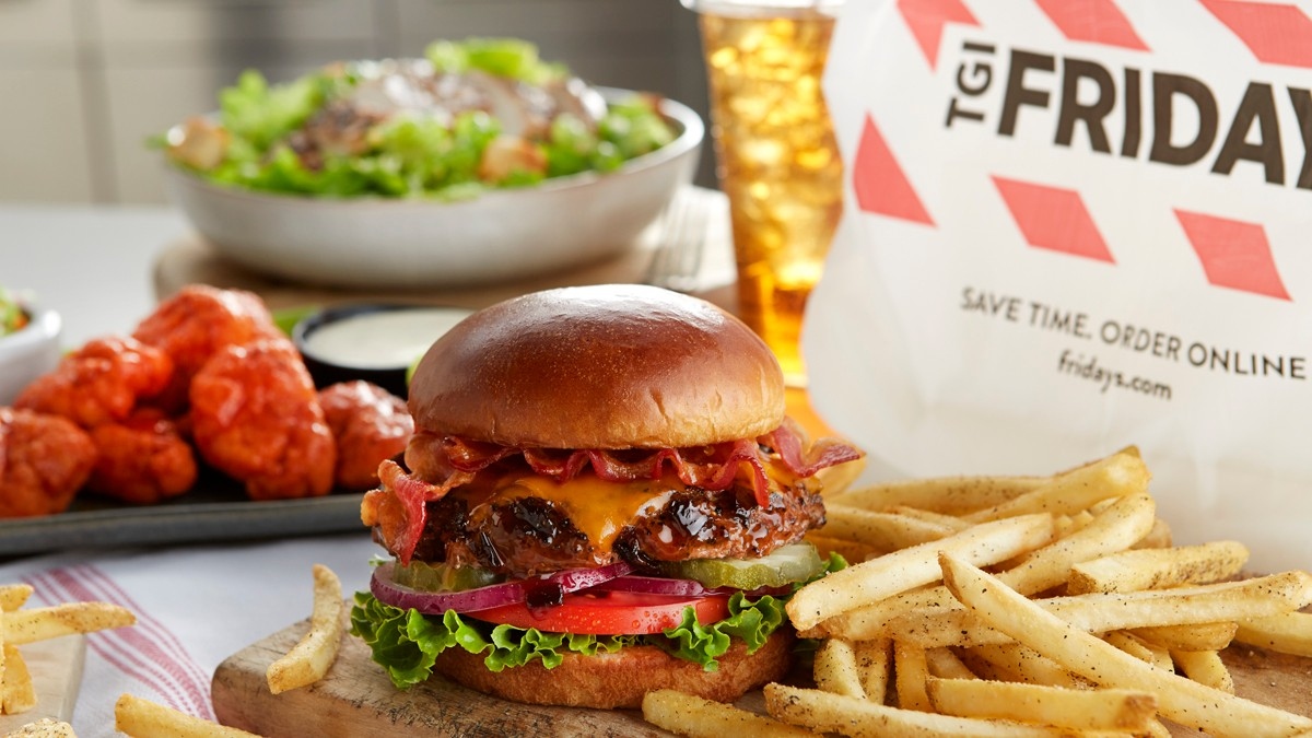 burger, fries, and wings next to TGI Fridays takout bag