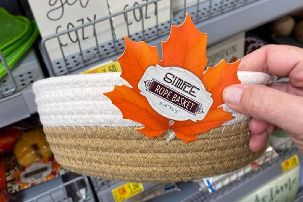 holding a rope basket with a leaf-shaped tag