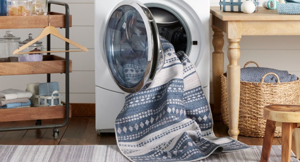 washable rug in laundry with baskets and other rugs around