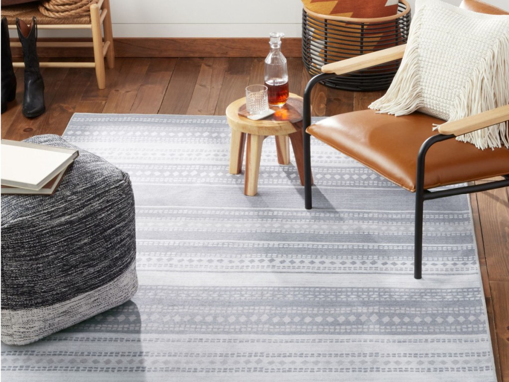 washable stripe rug displayed in the living room with chair and pffer-2