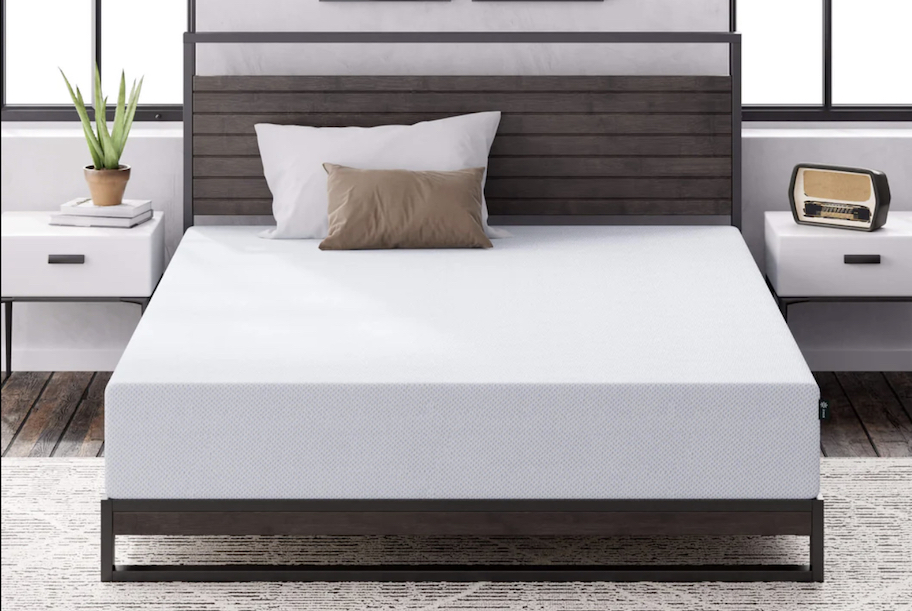 stock photo of white bare mattress on bedframe